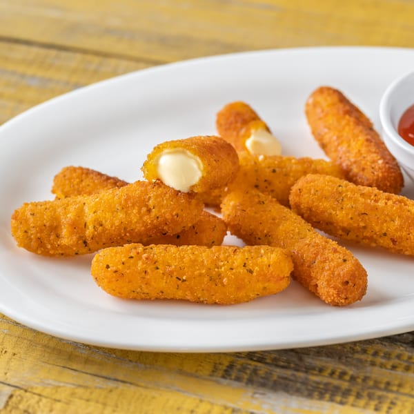 Golden-brown mozzarella sticks with one broken open to show melted cheese, served with a side of marinara.